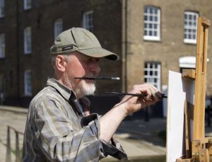 Image of Jonny Walsom painting on location